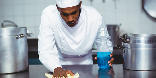 African American Chef wiping kitchen counter